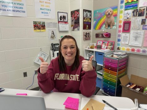 With two thumbs up, Ms. Burns prepares to teach her classes with a smile on her face.
